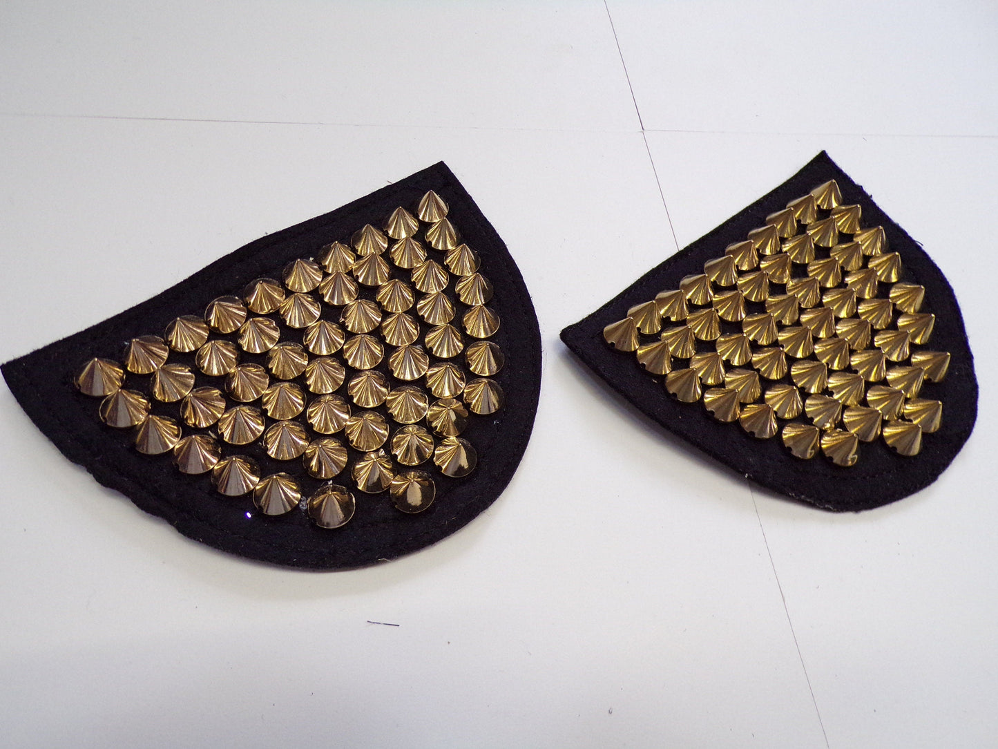 Epaulettes with studs in Gold sold as a pair. Spike gold stud trim, stud trim, shoulder stud trim