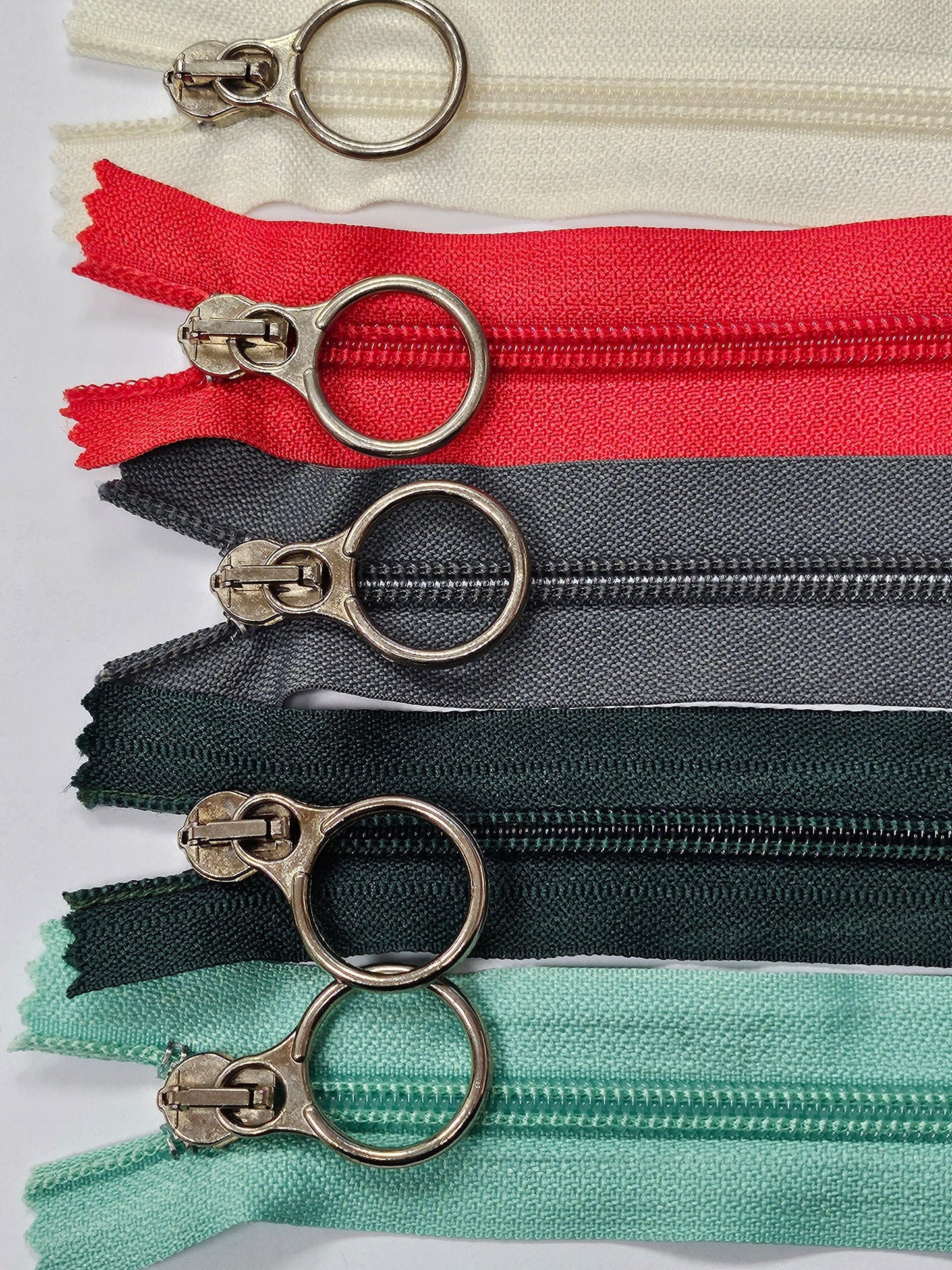 6" Closed ended zips, O-Ring Zips, metal ring/slider/puller, plastic teeth