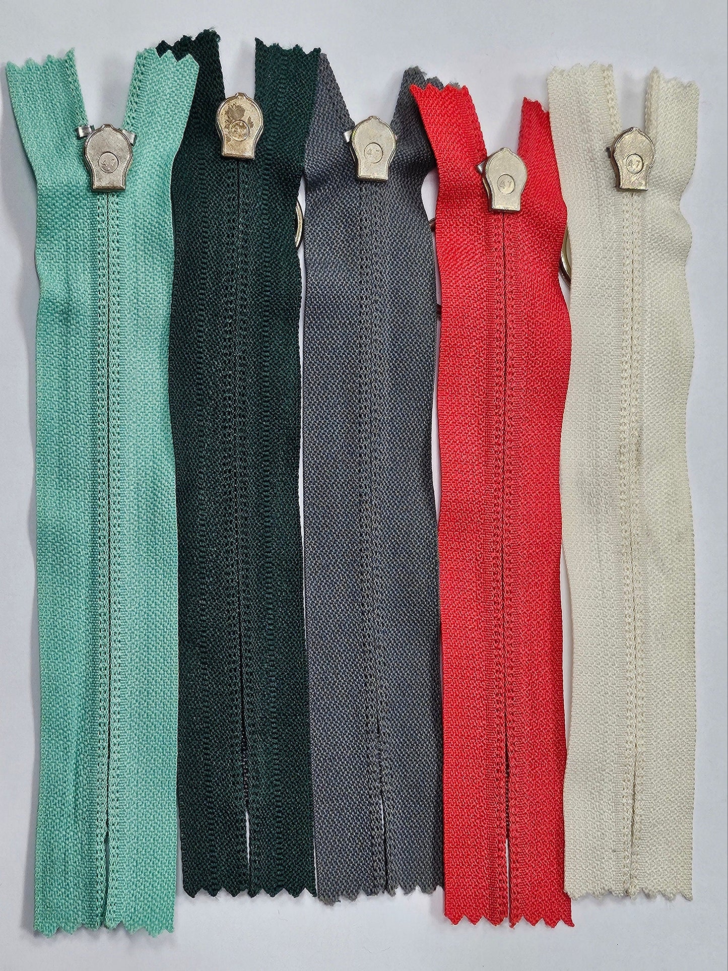 6" Closed ended zips, O-Ring Zips, metal ring/slider/puller, plastic teeth